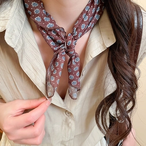 Close-up of vintage dark red floral scarf necklace with blue paisley print detail