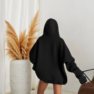 Detailed back view of an oversized black hoodie with loose drawstring and thick fabric