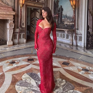 Elegant red lace long sleeve evening gown with a bodycon mermaid silhouette in a grand hall