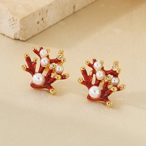 Macro view of red petal earrings with pearls and crystals on a minimalist background