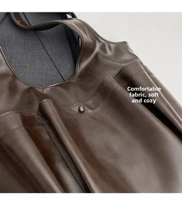 Close-up of deep brown PU leather tote bag with soft texture and refined stitching