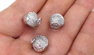 Three-piece set of pig-shaped jewelry charms featuring micro-pave white zircon and ruby eyes