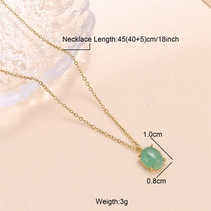 Detailed view of an 18k gold chain necklace with a green oval gemstone pendant