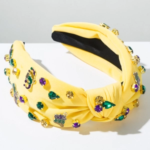 Detail of yellow knotted headband with Mardi Gras lettering and colorful faux gemstones