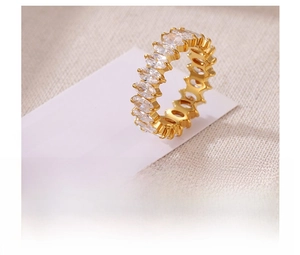 Macro view of gold plated titanium ring featuring marquise-cut cubic zirconia inlay