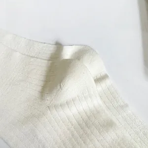 Close-up of fine ribbed texture and reinforced stitching on white combed cotton socks
