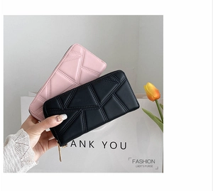 Detail of pink and black long wallets with geometric quilted PU leather and gold zippers
