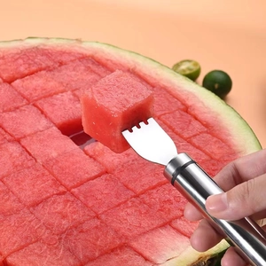 Stainless steel 2-in-1 watermelon slicer and fork tool on a pink background
