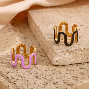 Detail of 18K gold plated wave rings with black and purple enamel on stone