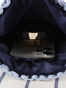 Internal view of gradient blue handwoven crossbody bag with phone and cosmetics