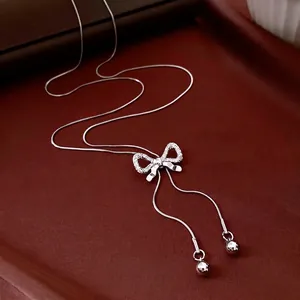 Silver bow pendant necklace with sparkling cubic zirconia on a minimalist snake chain