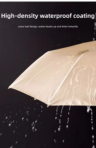 Close-up of champagne umbrella with high-density waterproof bionic coating showing water droplets