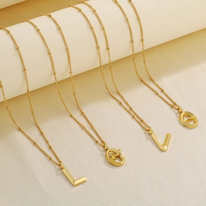 Detail of four gold satellite chain necklaces hanging with LOVE letter pendants