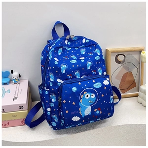 Detail view of blue kids backpack with cartoon dinosaur print in a study room setting