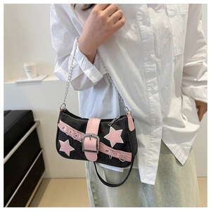 Close-up of Y2K denim bag with pink leather stars and silver chain strap detail