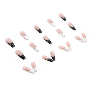Long ballerina press-on nails with black and white French tips and gold glitter accents