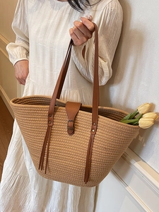 Handmade woven straw tote bag with brown leather straps and large capacity for beach
