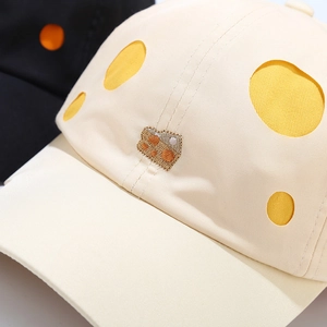 Detail of cream baseball cap with yellow polka dots and 3D cheese embroidery texture