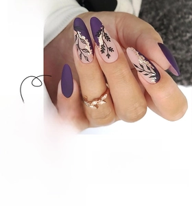 Detail of matte purple and nude press-on nails with leaf art and gold foil accents