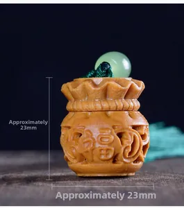 Macro detail of hand-carved sandalwood Fu bag pendant with green beads and silk tassel