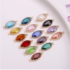 Macro shot of colorful marquise crystal pendants with double rings for DIY jewelry making
