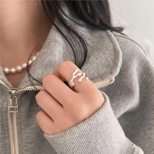 Close-up of irregular silver lava line ring worn by a model in minimalist style