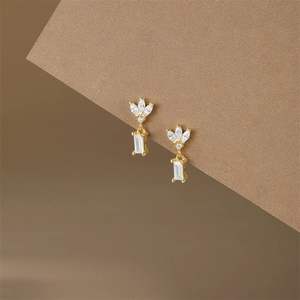 Detail of S925 silver vintage earrings with marquise and rectangular cubic zirconia
