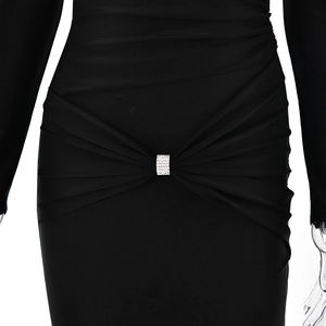 Detail of black slim-fit dress featuring pleated waist and sparkling rhinestone buckle