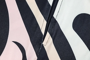Detail shot of the back zipper and geometric abstract print on slim fit jumpsuit