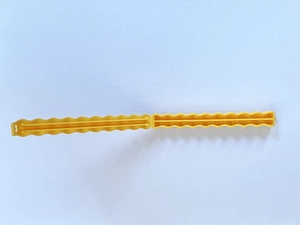 Macro detail of wave-shaped yellow plastic snack bag sealer clip for food preservation
