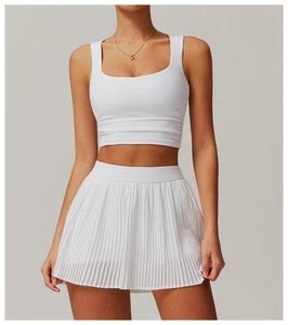 Detail of white square neck crop top and pleated tennis skirt set on high-elastic fabric