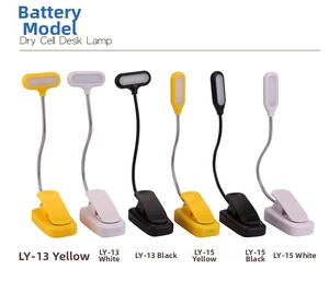 Multiple clip-on LED reading lamps in black, white, and yellow for study desk