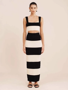 Women's two-piece knitted set featuring black and white stripes with a vest and maxi skirt
