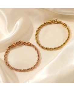 Detail shot of twisted rope chain bracelets in gold and rose gold with lobster clasp