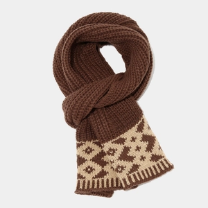 Detailed view of thick brown knit scarf with beige Nordic geometric jacquard pattern