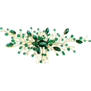 Handmade gold bridal hair comb with emerald green crystals and beads on white background