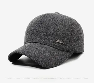 Detail of grey marl baseball cap featuring side metal fashion logo plate decoration