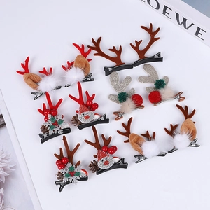 Various Christmas reindeer antler hair clips with plush balls and festive pine cones