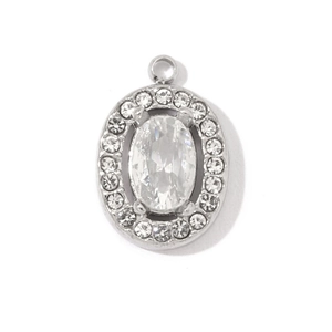 Close-up of silver oval pendant with large central zircon and halo of small stones