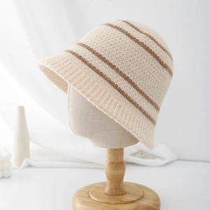 Close-up of beige waffle knit texture with brown stripes on a warm crochet bucket hat