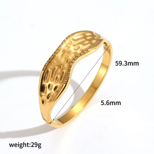 Irregular textured 18k gold plated stainless steel bangle with sparkling rhinestones