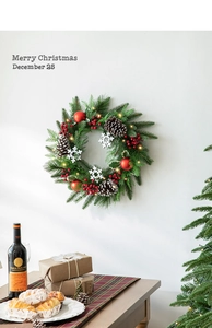 Close-up of a 40cm Christmas wreath with red berries, pine cones and warm LED lights
