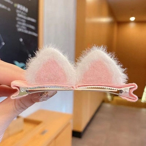Detail of plush pink and white cat ear hair clips with metal alligator base for girls