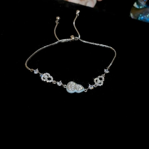 Detail of 18k gold plated bracelet showing zircon gourd and heart charms with pearls