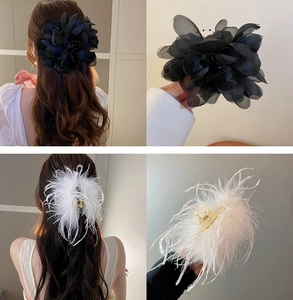 Detailed views of mesh flower and feather hair claw clips in black and white styles