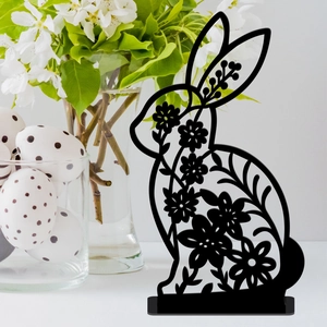 Detail of black hollow Easter bunny decor with floral patterns on a tabletop
