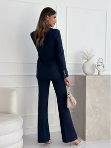 Detail of navy blue slim fit blazer with gold buttons on cuffs and matching trousers