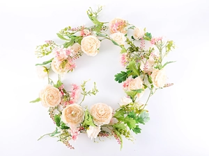 Detailed view of artificial champagne rose and peony garland on white background
