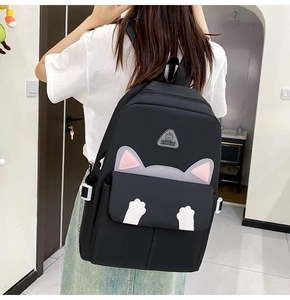 Detail of cute cat design backpack with grey pink ears and white paw decoration