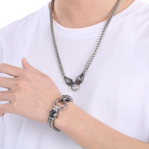 Close-up of 6mm dragon bone chain with double snake head details on model with white tee